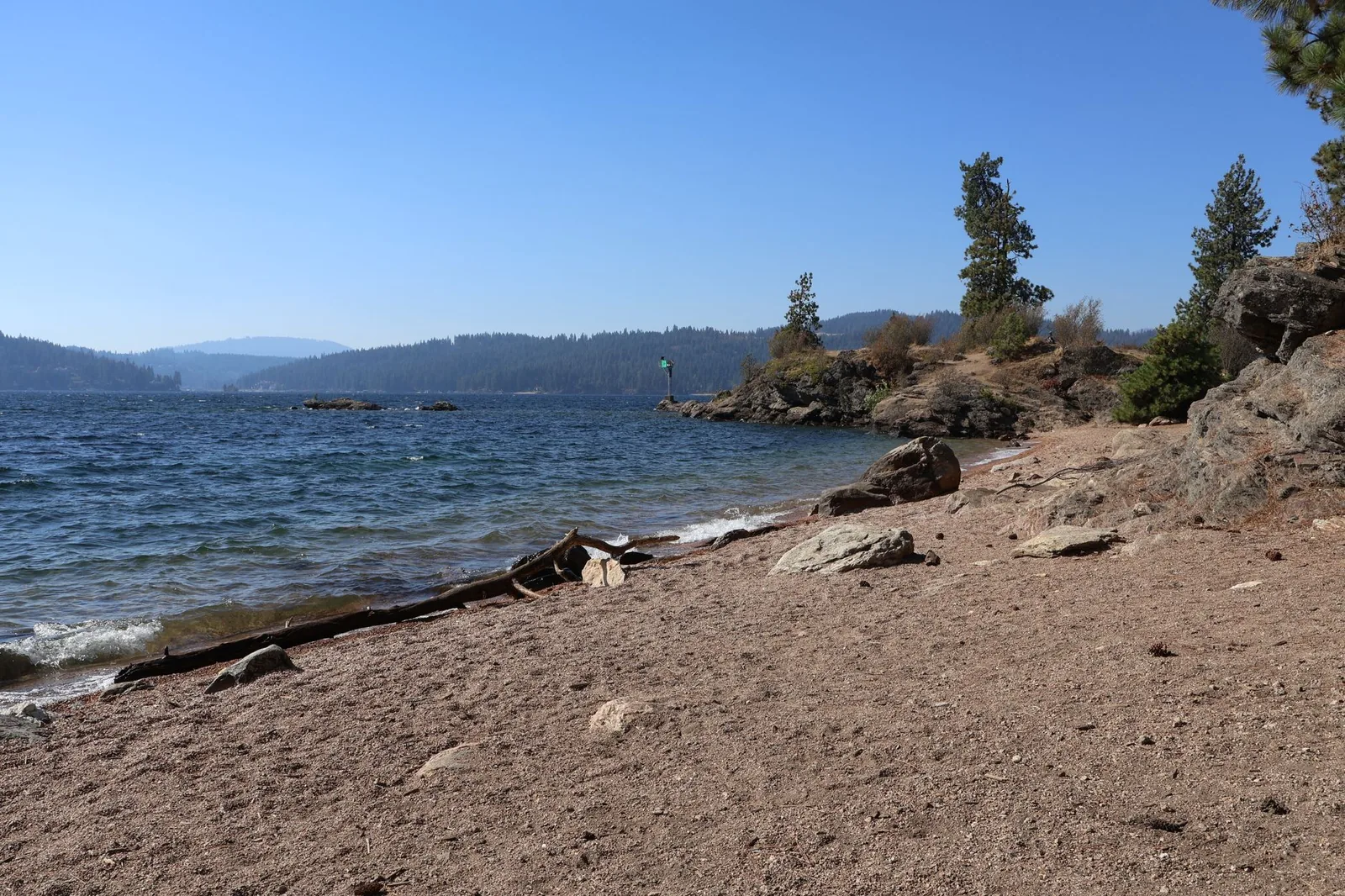 Coeur d'Alene Lake with mountains and clear skies in northern Idaho