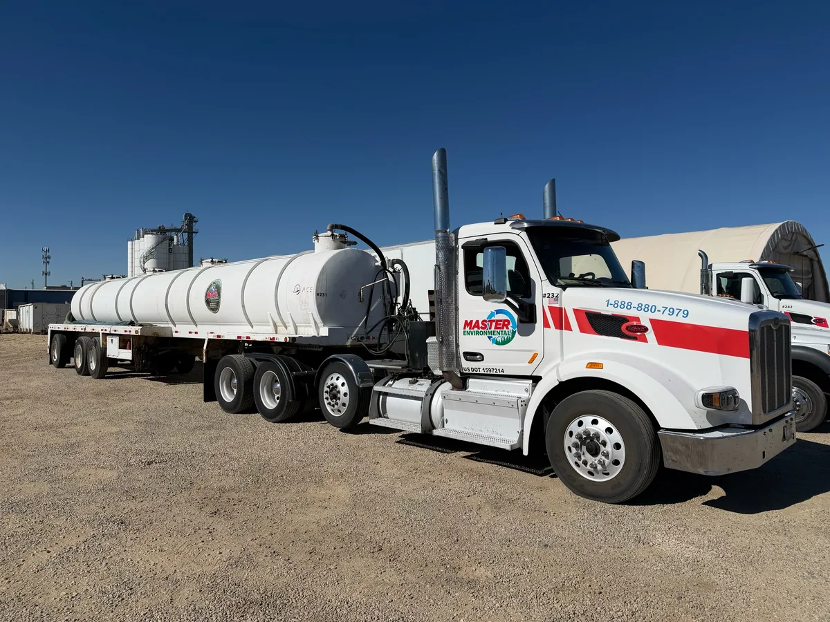 Master Environmental tanker truck staged at an industrial service yard